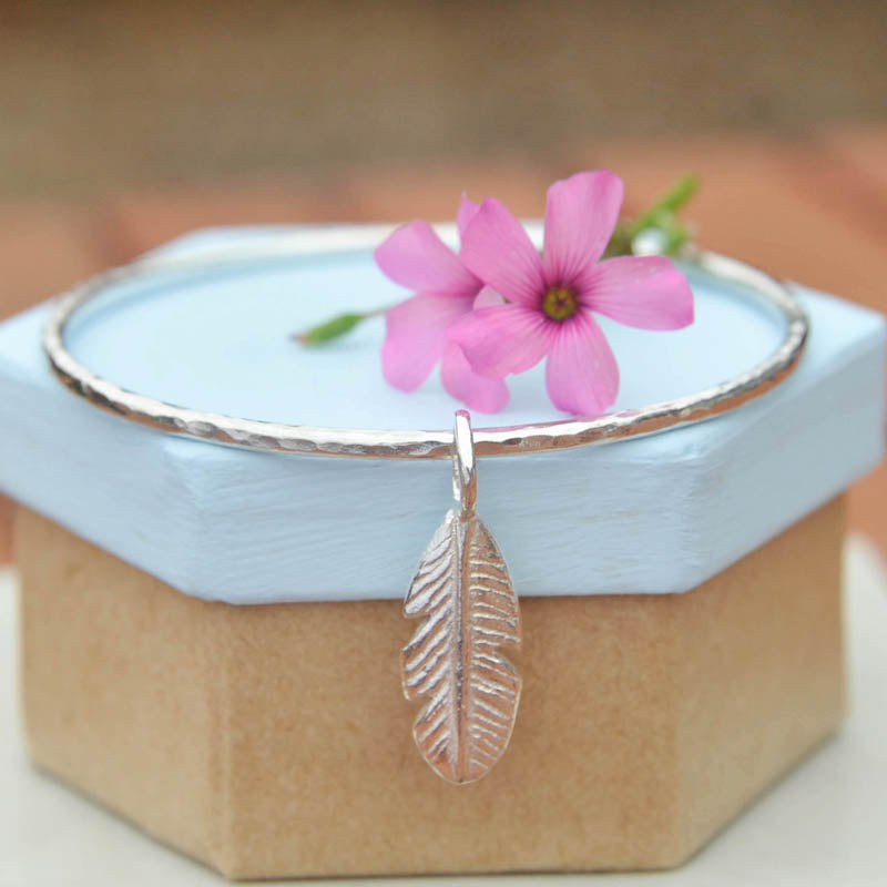  Silver stacking hammered bangle with feather charm